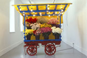 Micheal Landy, Costermonger Stall No.3, 1991, Life sized Flowerstall (steel, wood, tarpaulin, lighting fixtures,flower buckets) & fresh flowers., 239 x 183 x 122 cm, Collection Irish Museum of Modern Art, Loan, Weltkunst Foundation, 1996 Micheal Landy, Costermonger Stall No.3, 1991, Life sized Flowerstall (steel, wood, tarpaulin, lighting fixtures,flower buckets) & fresh flowers., 239 x 183 x 122 cm, Collection Irish Museum of Modern Art, Loan, Weltkunst Foundation, 1996