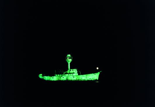Dorothy Cross, Ghost Ship, 1999 , Two light ship models, phosphorescent paint and u.v.lights, video, 10 minute loop, Collection Irish Museum of Modern Art, Purchase, 2003