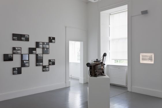 Gerard Byrne, Case Study: Loch Ness (some possibilities and problems), 2001- ongoing, Photographic elements combined in multi-various permutations, vitrines, tree stumps with accompanying wall drawings, avant garde poetry forms and experimental film. Courtesy of the artist, Installation view Irish Museum of Modern Art, Photo: Denis Mortell