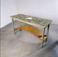 Dorothy Cross, Kitchen Table, 1991, 90 x 162 x 60 cm, Wood, enamel bowl, steel, glass test tube, fossilised shark teeth, Collection Irish Museum of Modern Art, Photo credit: John Kellett Dorothy Cross, Kitchen Table, 1991, 90 x 162 x 60 cm, Wood, enamel bowl, steel, glass test tube, fossilised shark teeth, Collection Irish Museum of Modern Art, Photo credit: John Kellett
